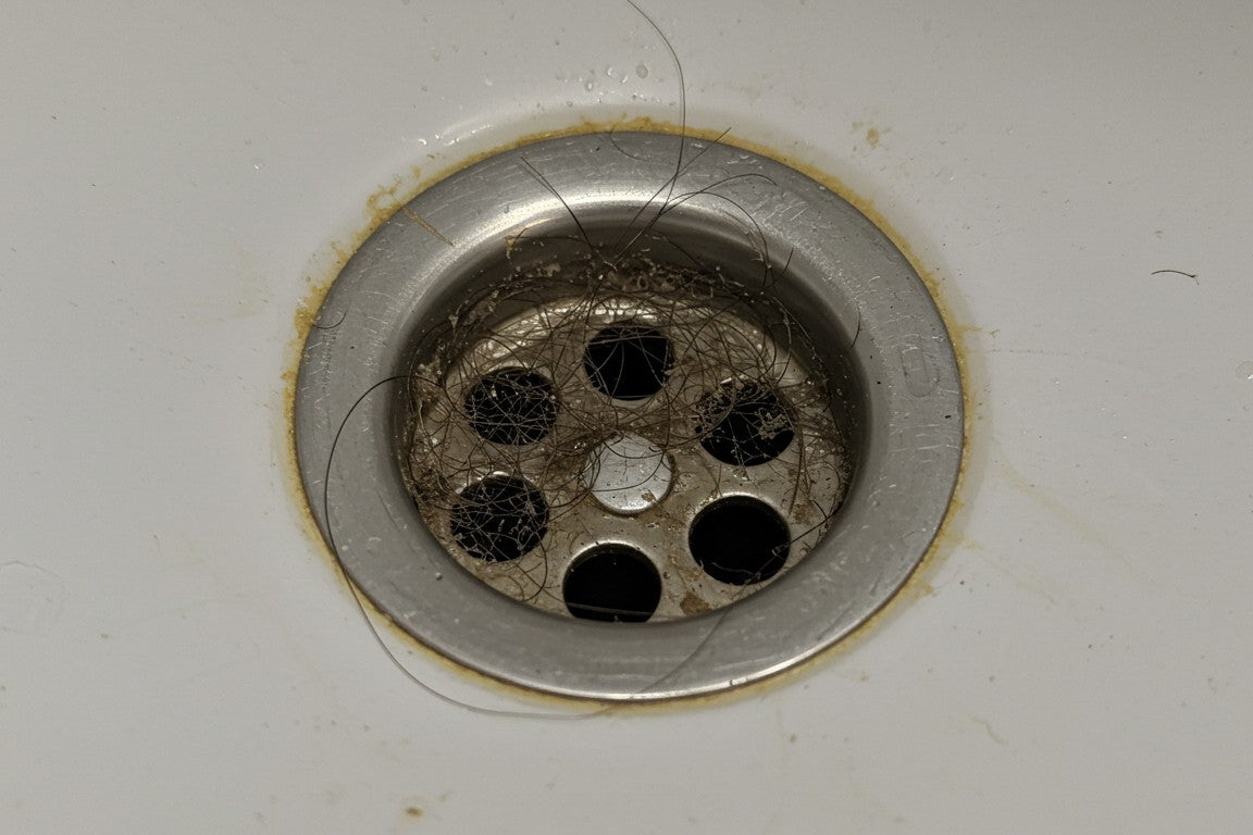 How to clean hair and soap scum from drains